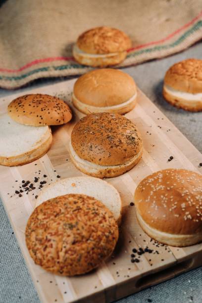 istock Freshly baked burger buns on wooden board 1433346362