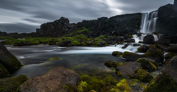 A mesmerizing scenery of a waterfall during the sunset