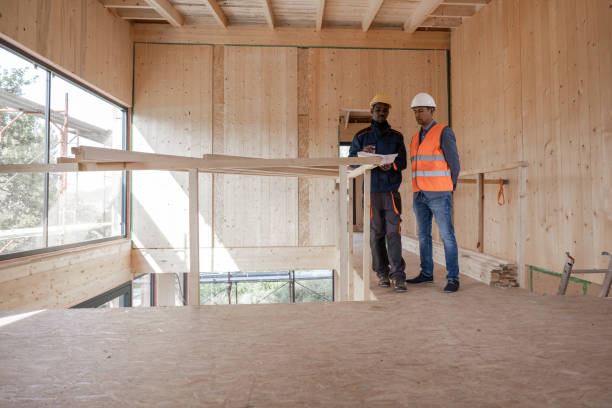 istock The worker and foreman are look some details on blueprint 1433347611