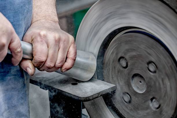 istock Closeup of master's hands working on knife sharpener machine in factory 1433350544