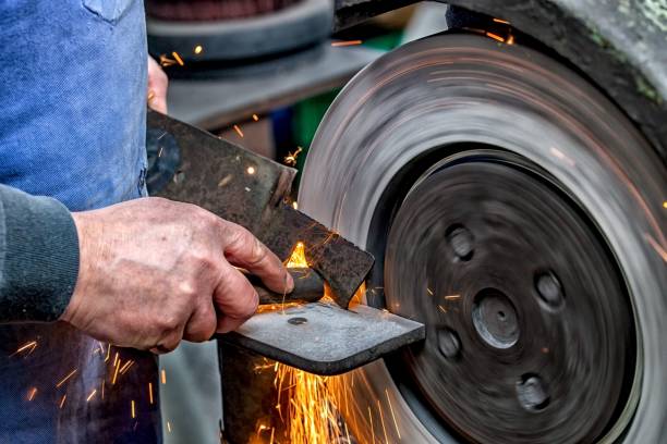 istock Closeup of master's hands working on knife sharpener machine in factory 1433350547