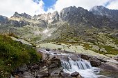 Sesterske Pleso (sister pond) waterfall with high rocks in the background, High Tatras, Slovakia