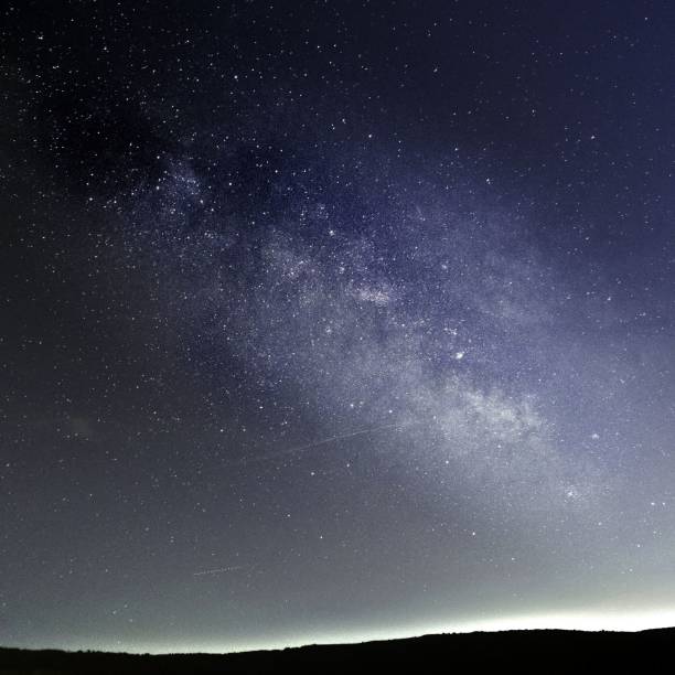 istock Mesmerizing night vista scene with starry sky over silhouetted trees, perfect for background 1433351115