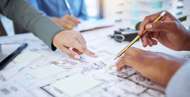 istock Architect, planning or blueprint with a designer and engineer working as a team in construction, architecture and design industry. Building, teamwork and collaboration with the hands of a contractor 1433351162