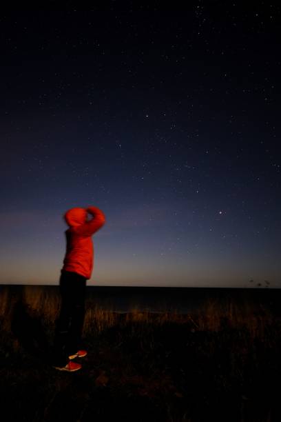 istock Human standing and looking at night sky with blsisful Milky way 1433351202