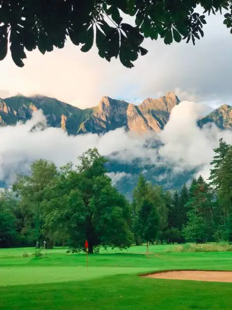 A natural view of a greenfield and mountain landscape on a cloudy day in Bad Ragaz, Switzerland