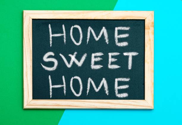 istock Blackboard with 'Home sweet home' writing, on a green and blue wall 1433353721