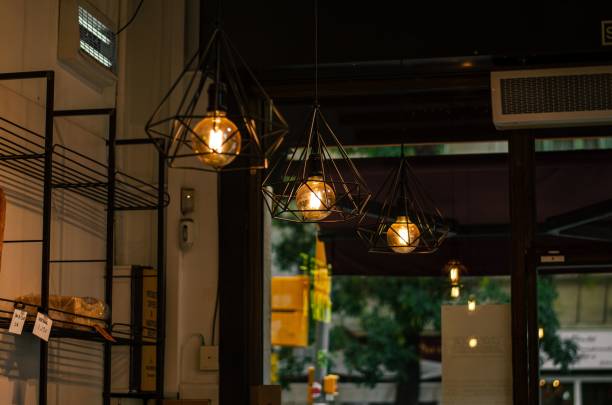 istock Lightbulbs with metallic carcasses hanging in a cafe 1433354174