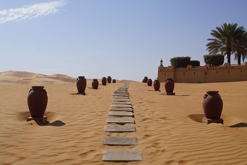 A sandy walk with stones in Qasr Al Sarab desert resort in Abu Dhabi, the United Arab Emirates