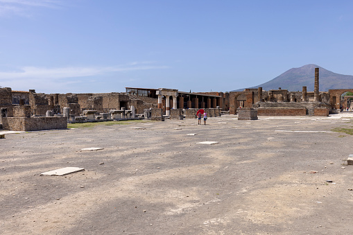 Pompeii, Naples, Italy - June 26, 2021: Forum of city destroyed by the eruption of the volcano Vesuvius in 79 AD, view of mount Vesuvius