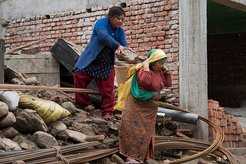 Kathmandu, Nepal- April 20,2022 : Local people of all ages and genders are working to rebuild the ruined old city in a major earthquake in Patan Durbar Square.