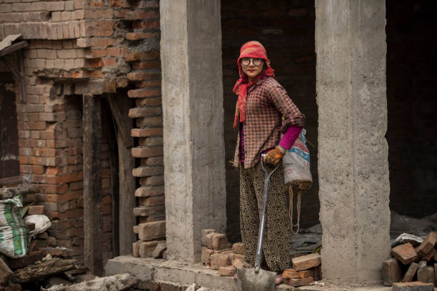 Construction works in Patan Durbar Square in Kathmandu, Nepal. Kathmandu, Nepal- April 20,2022 : Local people of all ages and genders are working to rebuild the ruined old city in a major earthquake in Patan Durbar Square. patan durbar square stock pictures, royalty-free photos & images