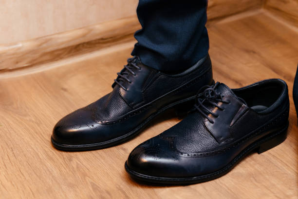 istock Black leather shoes on a brown floor 1433357437