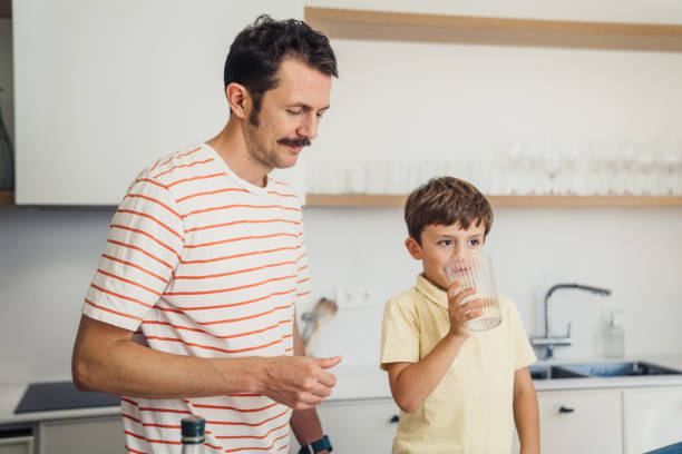 istock Boy drinking glass of water 1433360745