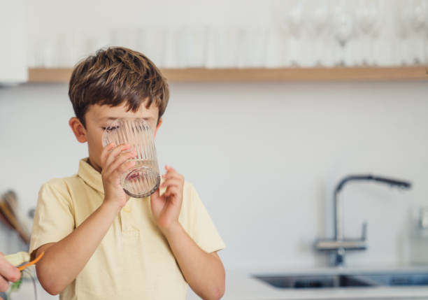 istock Boy drinking glass of water 1433360746