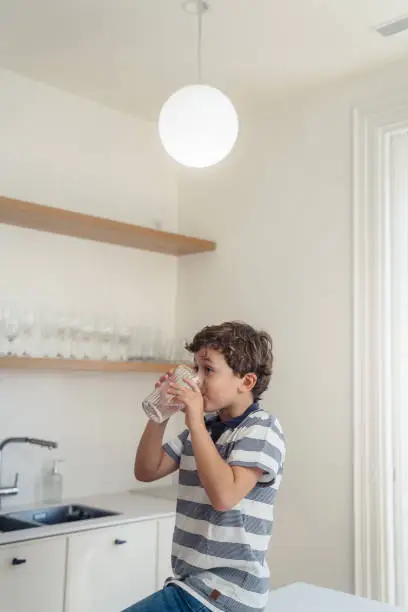 Photo of Boy drinking glass of water