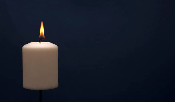 istock Wax candle with a blue dark back flame 1433361109