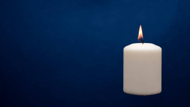 istock Wax candle with a blue dark back flame 1433361126