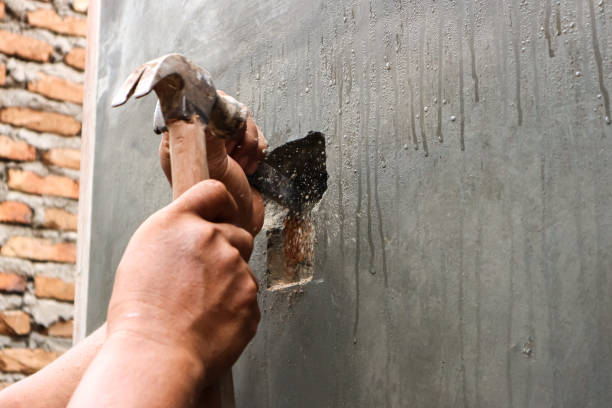 Indonesian hands man Holding hammers and iron chisels to punch holes in stone walls View of Indonesian hands man Holding hammers and iron chisels to punch holes in stone walls to install electrical wires. Selective focuss blurry background rumah stock pictures, royalty-free photos & images
