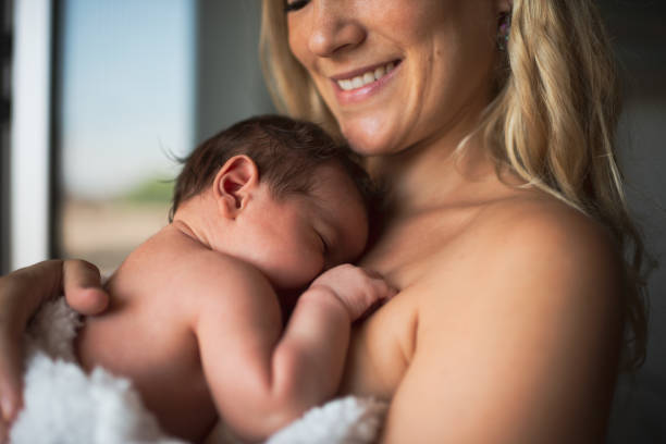 istock Newborn baby in mother's arms 1433367125