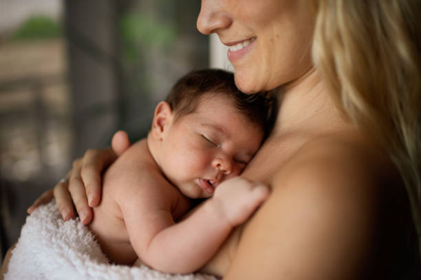 istock Newborn baby in mother's arms 1433367391