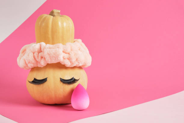 istock pumpkin in a headband and false eyelashes on a pink background, sponges for applying makeup beauty salon 1433367478
