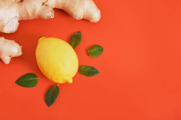istock lemons,ginger root and mint leaves on red background 1433367815