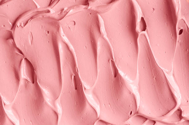 istock Pale pink cosmetic clay (lip gloss, alginate modeling facial mask, face cream, body wrap) texture close up, selective focus. Abstract background with brush strokes. 1433368705