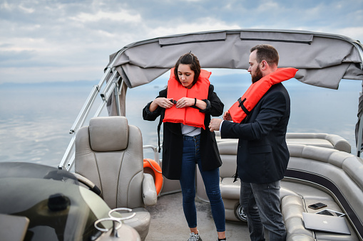 Business Coupe Strapping On Life Jackets After Catamaran Malfunctions In Middle Of Lake