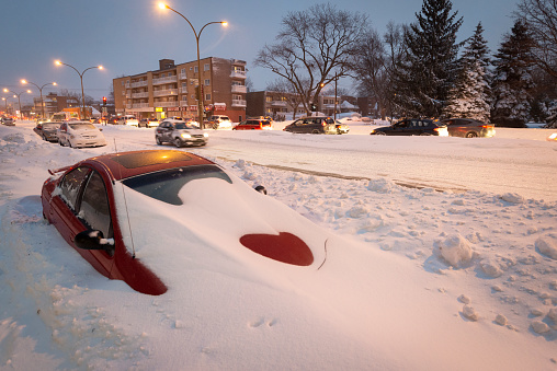 Buried car in street during snow storm in Montreal Canada