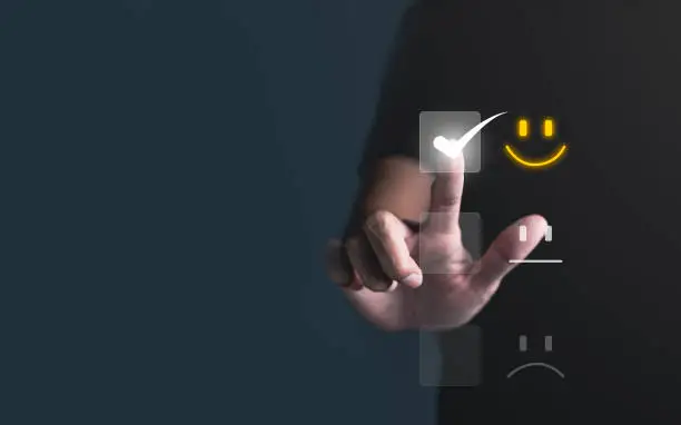 Photo of Businessman pressing smiley face emoticon on virtual touch screen. best rating positive, Customer service evaluation concept. quality review, feedback survey, marketing performance, satisfaction user.