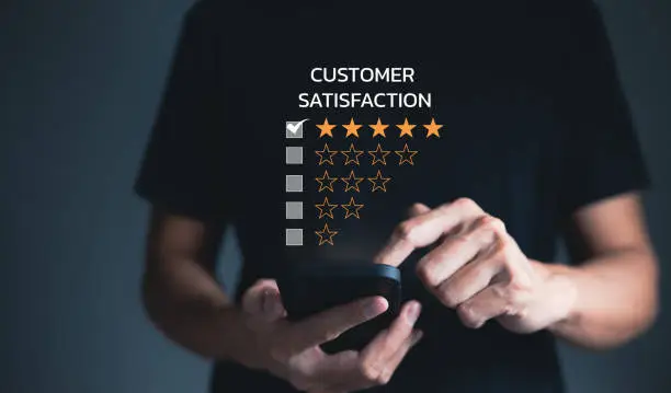 Photo of Customer review satisfaction feedback survey concept, user gives rating to service experience on online application, Customer can evaluate quality of service leading to reputation ranking of business.