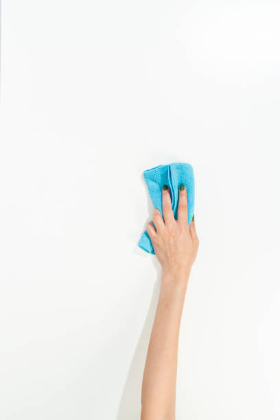 istock woman hand holding cleaning cloth on white background 1433376895