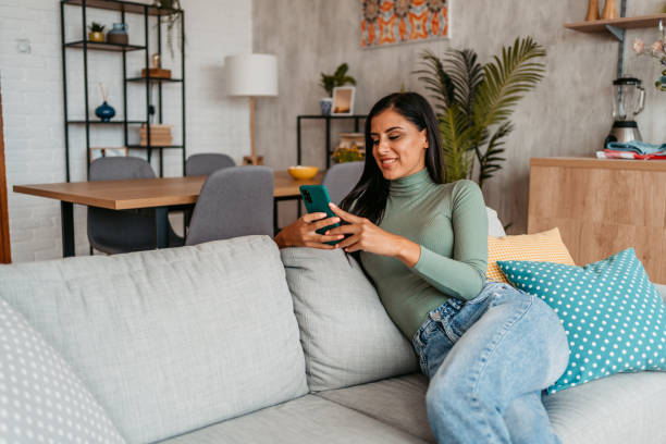 istock Young Woman Texting On The Phone At Home 1433383935