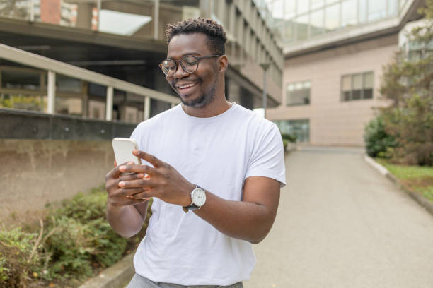 istock Smiling man looking at smart phone 1433383936