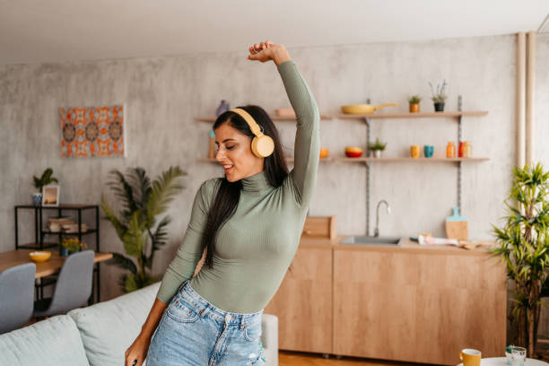 istock Young Woman Singing And Dancing At Home 1433385109