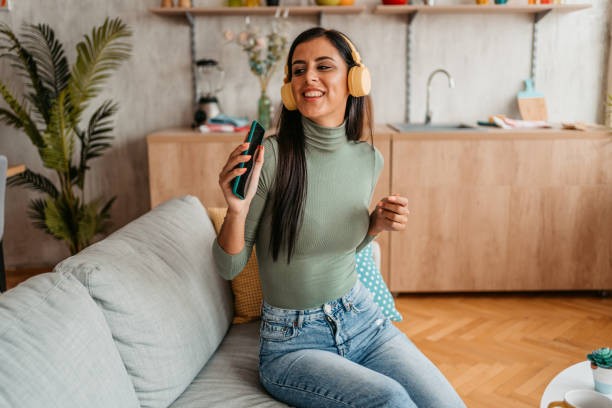 istock Young Woman Singing And Dancing At Home 1433385419
