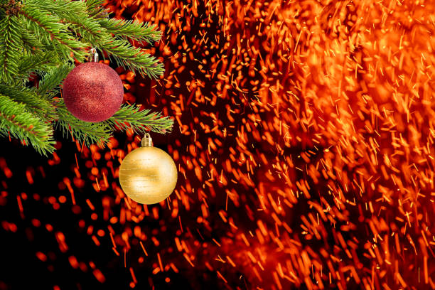 Celebration background with a Christmas tree decorated with Christmas balls and flying sparks