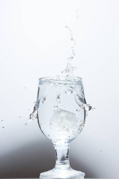 istock Ice cube fell into the glass of water. Fresh concept 1433385512