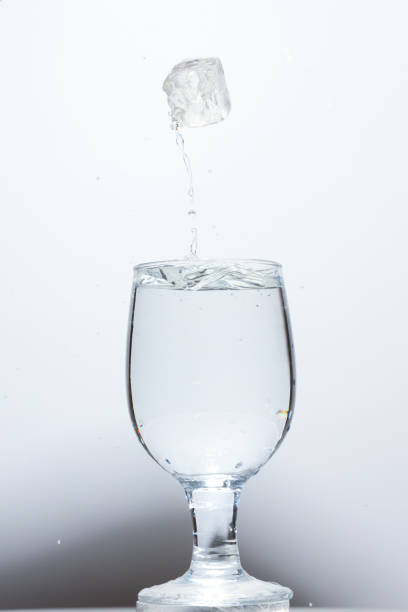 istock Ice cube fell into the glass of water. Fresh concept 1433385515