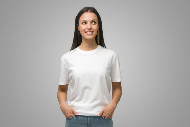 istock Young lady in casual clothes looking aside planning something on grey background 1433385535