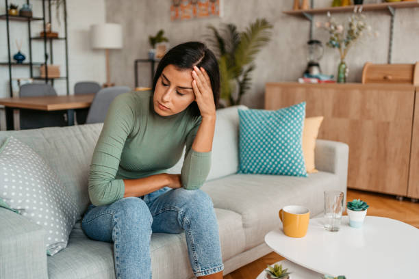 istock Young Woman Having A Headache At Home 1433385865
