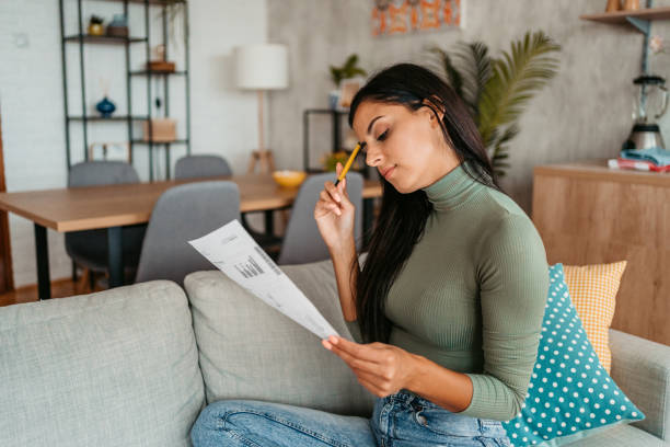 istock Young Woman Checking Her Finances At Home 1433386196