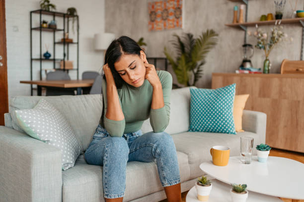 istock Sad Young Woman Sitting On The Sofa At Home 1433386232
