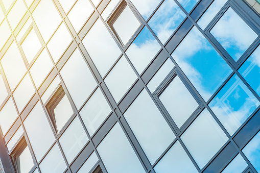 Glass wall of windows. Skyscraper business center. Background on the theme of work and development.