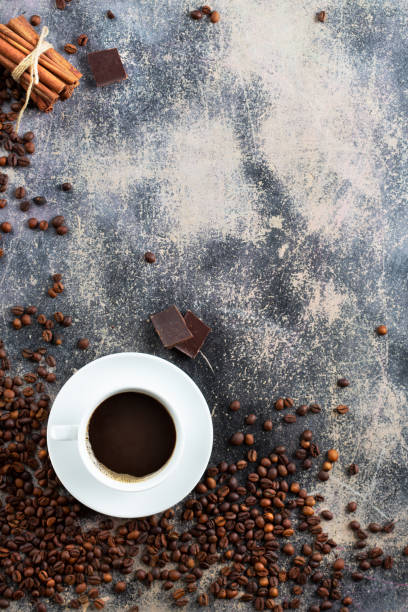 istock freshly brewed coffee in a classic white cup and deep roasted coffee beans on an old shabby plywood background, chocolate and cinnamon as serving elements 1433387390