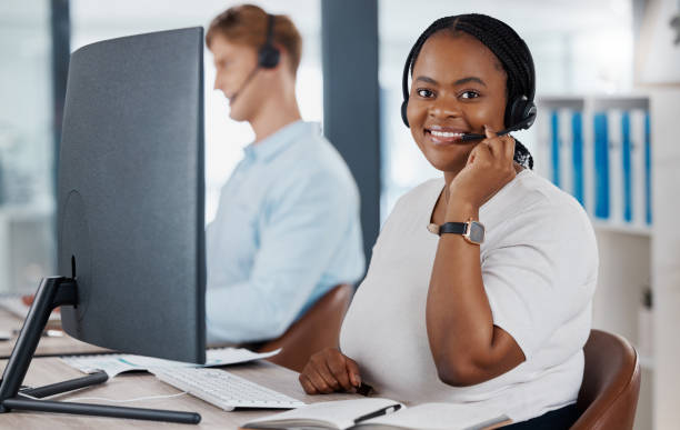 istock Sales, support and customer service call center consultant smiling while consulting with online clients in office. Contact us with happy agent enjoying job in telesales, excited about good service 1433387826