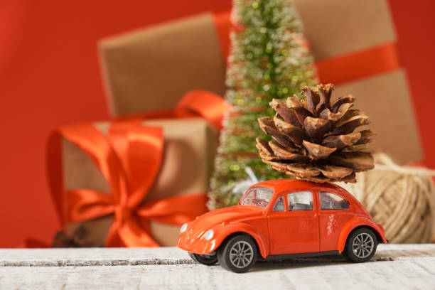 istock miniature red retro car model, christmas background 1433389245
