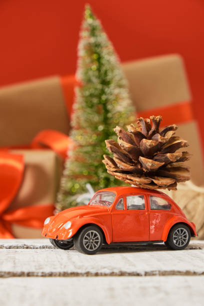istock miniature red retro car model, christmas background 1433389247