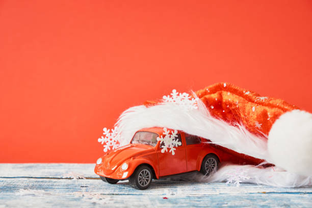 istock miniature red retro car model, christmas background 1433389248